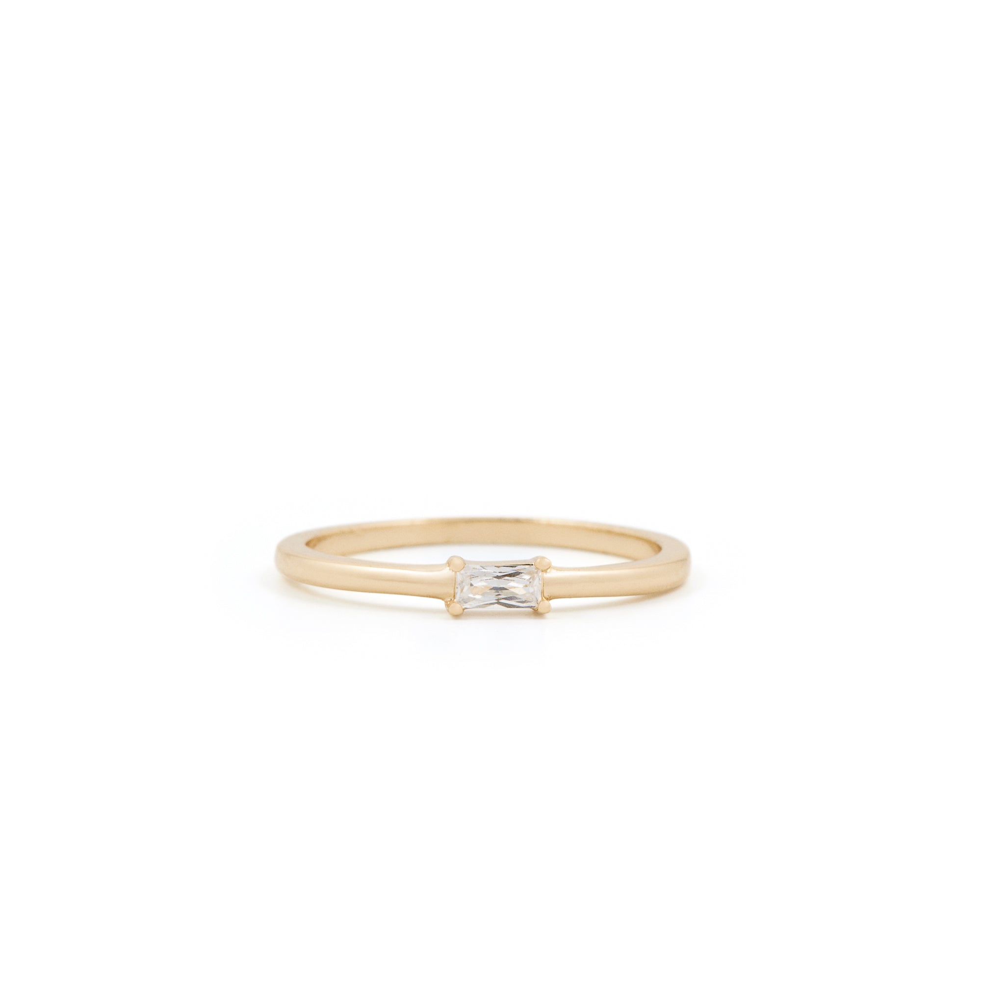 A simple, elegant Alaska Ring by Twenty Compass, made of gold vermeil with a small rectangular diamond in the center, is displayed on a plain white background, showcasing its understated charm.