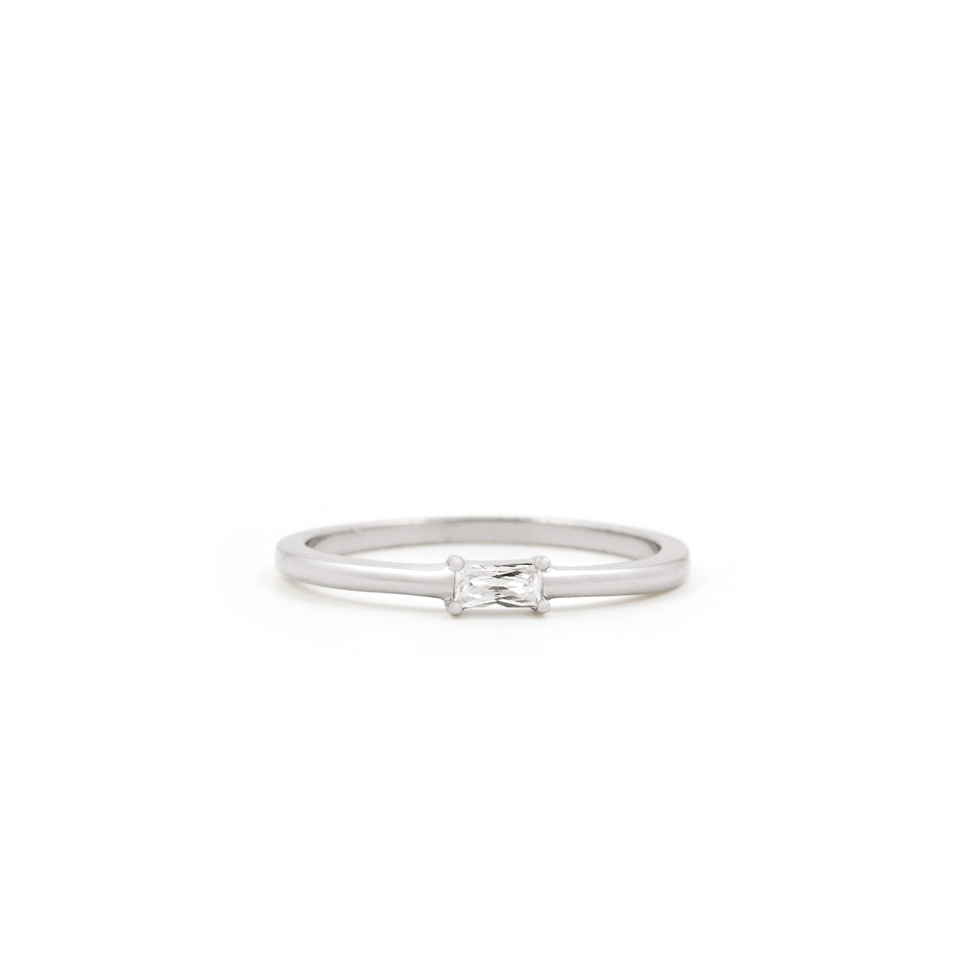 The Twenty Compass Alaska Ring - Silver is a minimalist band with a delicate, sparkly rectangular gemstone at the center, shown on a white background.